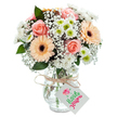 A celebration of contemporary culture and enduring elegance, this artful bouquet brightens any Whitechapel setting with its blend of soft hues and subtle details. Focal peach-pink roses unfurl luxuriously, their silky petals forming gentle spirals that whisper of affection and the comfort of home. Two welcoming gerbera daisies in shades of gentle peach and orange, anchored by striking brown centres, add a lively and sunny character that invokes the bustle of Whitechapel High Street. Downy, cloud-like sprigs of white gypsophila thread gracefully through the bouquet, creating a dreamy, weightless effect, while clusters of crisp white chrysanthemums bring additional volume-each bloom revealing a vibrant green centre that shimmers in the light. Lush sprigs of eucalyptus lend depth and a faint herbal aroma, balancing the softer tones. Set in a clear, textured glass vase that highlights the clean lines of the stems and brilliant water, the arrangement is finished with a rustic twine bow and an inviting white gift tag, ready to be personalized. This bouquet beautifully expresses heartfelt occasions and everyday gratitude alike, making it an ideal choice for speedy, thoughtful flower delivery throughout Whitechapel's E1.